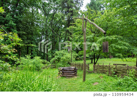 Wooden ancient water well. Halych Ethnography museum, Ukraine. Wooden ancient water well. Halych Ethnography museum, Ukraine. 110959434