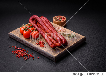 Delicious thin smoked hunting sausages with salt, spices and herbs Delicious thin smoked hunting sausages with salt, spices and herbs 110959454