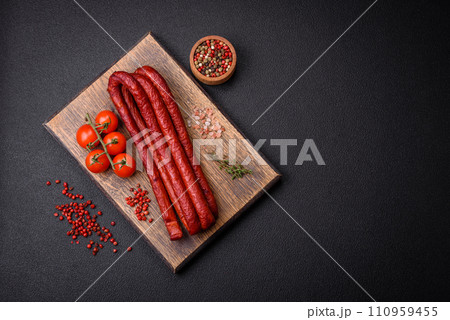 Delicious thin smoked hunting sausages with salt, spices and herbs Delicious thin smoked hunting sausages with salt, spices and herbs 110959455