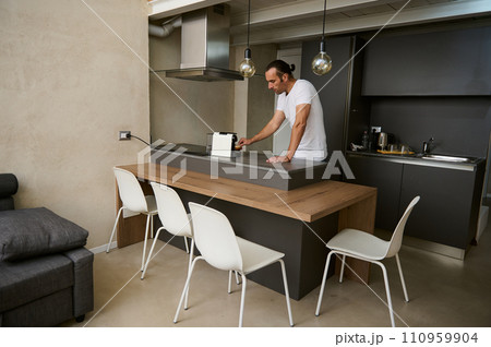 Young adult man making coffee a home 110959904