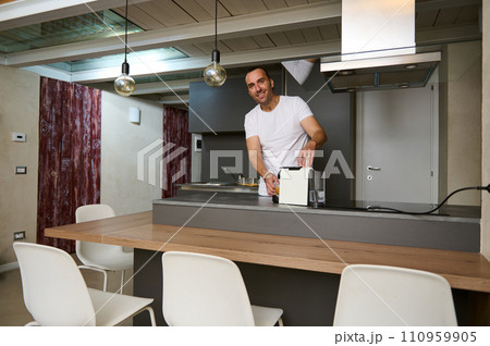 Young adult man making coffee a home 110959905