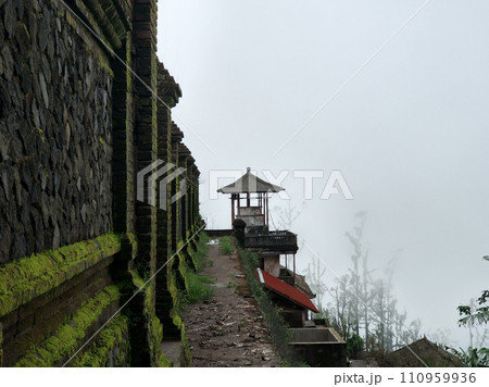 The stark stone wall of the temple on the mountain is covered with moss. The stark stone wall of the temple on the mountain is covered with moss. 110959936