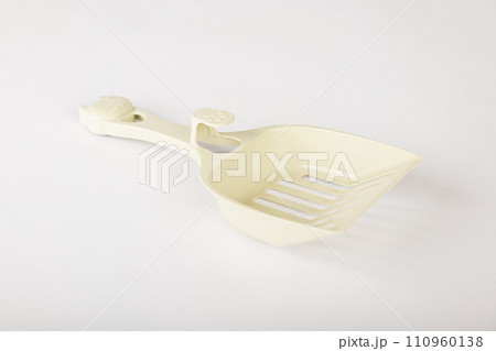 Isolated on a clean white background metal cat litter scoops are essential for maintaining hygiene and cleanliness in your cat's litter box. Purity and care are a scoop away. 110960138