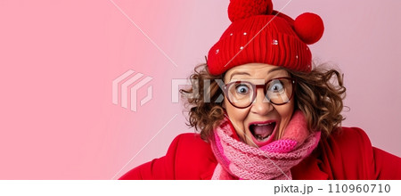 Elderly woman in knitted hat and scarf looking away, isolated on pastel background with copy space 110960710