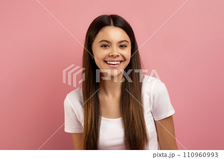 Portrait of happy teenage girl with beautiful smile looking at camera 110960993
