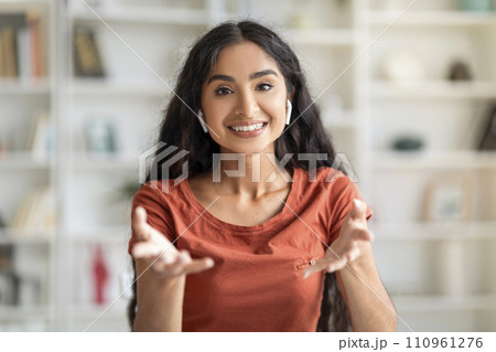 Focused Young Adult Hindu Lady Navigating Virtual Work 110961276