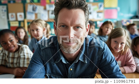 Smiling male teacher in elementary school classroom with eager students listening and learning Smiling male teacher in elementary school classroom with eager students listening and learning 110961791