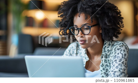 Creative young woman working on laptop in her stylishly decorated home studio with modern design 110961865