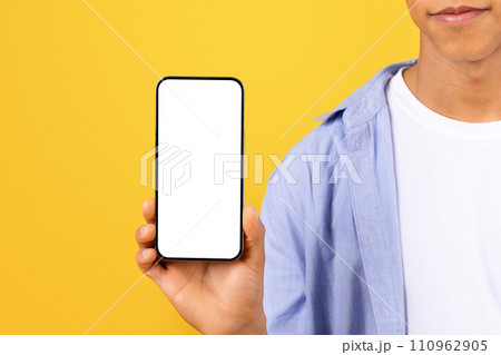 Black man in blue shirt presenting smartphone screen 110962905