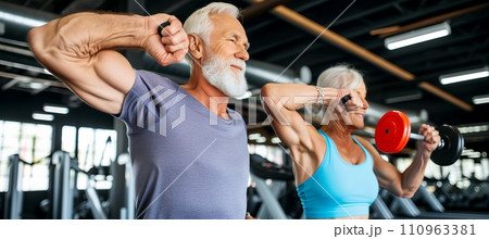 Energetic senior couple jogging together in health club for active lifestyle and fitness Energetic senior couple jogging together in health club for active lifestyle and fitness 110963381