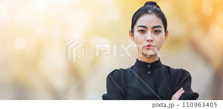 Professional young businesswoman portrait outdoors with blurred business center background 110963405