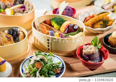 Japanese food in bamboo containers, closeup of a Japanese meal. 110963828