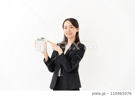 電卓を持つ若い女性 ビジネス 指差し 電卓を持つ若い女性 ビジネス 指差し 110965076