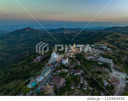 .Aerial view White buddha in Wat Phra That Pha Son Kaew temple at sunset. 110968498