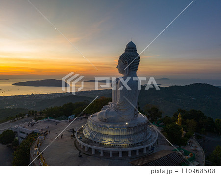 aerial view bright golden sun ray shine on the head of Phuket big Buddha.. aerial view bright golden sun ray shine on the head of Phuket big Buddha.. 110968508