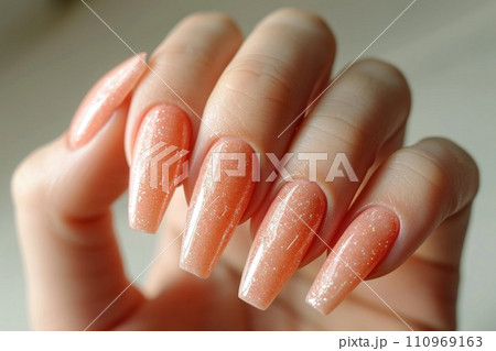 Hand with delicate peach manicure 110969163
