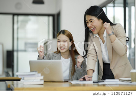 Excited Businesswomen Celebrating Success at Work. Excited Businesswomen Celebrating Success at Work. 110971127