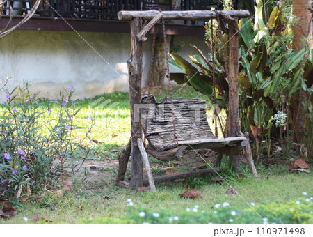 old wooden swing in the garden old wooden swing in the garden 110971498