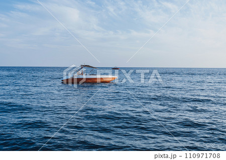 boat anchored in the sea. Mediterranean Sea. coastline and rescue boat boat anchored in the sea. Mediterranean Sea. coastline and rescue boat 110971708