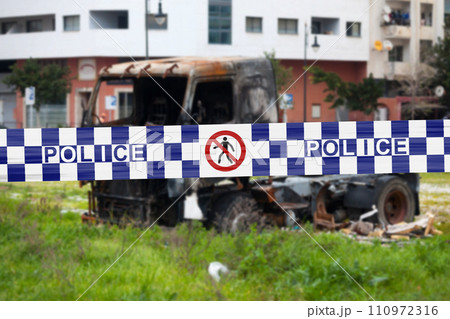 Australian police tape barricading a burnt truck Australian police tape barricading a burnt truck 110972316