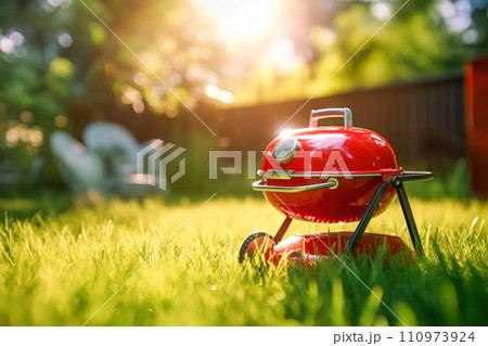 Backyard with red bbq grill on sunny grass field. AI content Backyard with red bbq grill on sunny grass field. AI content 110973924
