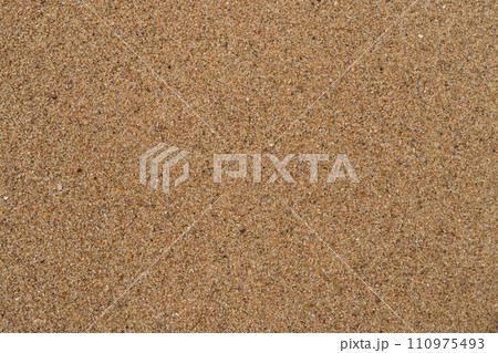 Texture of wet sand on a beach top view 110975493