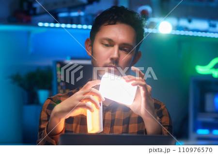Compact, portable mini LED lamp isolated on a bright background. 110976570