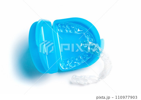 Top view of Invisible aligners for whitening and straightening of teeth with blue box  110977903