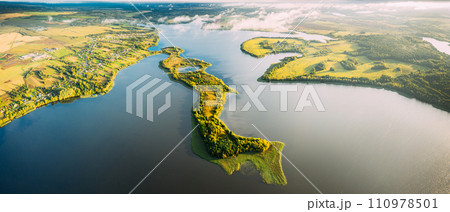 Lyepyel District, Lepel Lake, Beloozerny District, Vitebsk Region. Aerial View Of Residential Area With Houses In Countryside. Top View Of Island From High Attitude In Autumn Morning. Bird's Eye View Lyepyel District, Lepel Lake, Beloozerny District, Vitebsk Region. Aerial View Of Residential Area With Houses In Countryside. Top View Of Island From High Attitude In Autumn Morning. Bird's Eye View 110978501
