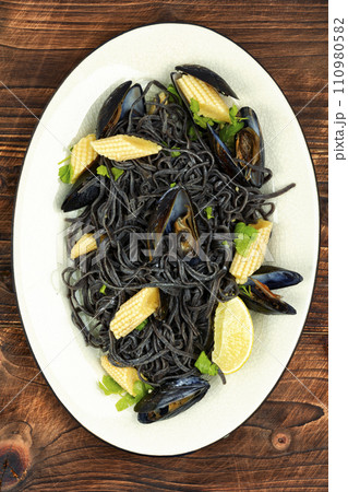 Black spaghetti pasta with clams. 110980582