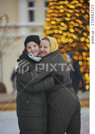 Mom and teenage daughter at an ice rink in Denmark at Christmas Mom and teenage daughter at an ice rink in Denmark at Christmas 110982323