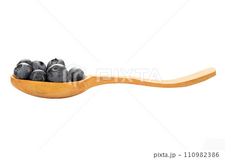 Wild blueberry in a wooden spoon isolated on a white background. Wild blueberry in a wooden spoon isolated on a white background. 110982386