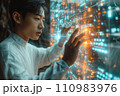 young asian man working with futuristic screen interface 110983976