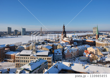 Panoramic view from tower of Saint Peters Church on Riga Cathedral and roofs of old houses in old city of Riga, Latvia in winter. Panoramic view from tower of Saint Peters Church on Riga Cathedral and roofs of old houses in old city of Riga, Latvia in winter. 110985855