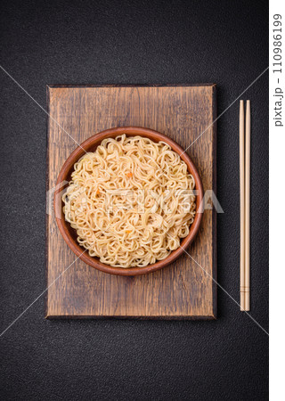 Delicious Asian cuisine dish with rice noodles, peppers, mushrooms and spices 110986199