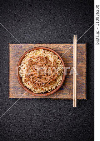 Delicious Asian cuisine dish with rice noodles, peppers, mushrooms and spices 110986200
