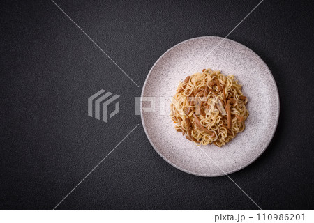 Delicious Asian cuisine dish with rice noodles, peppers, mushrooms and spices 110986201