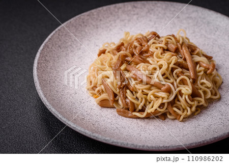 Delicious Asian cuisine dish with rice noodles, peppers, mushrooms and spices 110986202