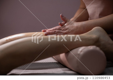 Close-up of a woman's leg massage in a salon. Close-up of a woman's leg massage in a salon. 110986453