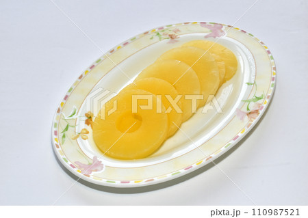 Pineapple lies in circles on a plate. Pineapple lies in circles on a plate. 110987521