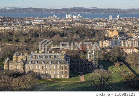 Aerial view of Palace of Holyroodhouse and Holyrood Park seen from the top of Salisbury Crags. Amazing Edinburgh Cityscape. Aerial view of Palace of Holyroodhouse and Holyrood Park seen from the top of Salisbury Crags. Amazing Edinburgh Cityscape. 110988125