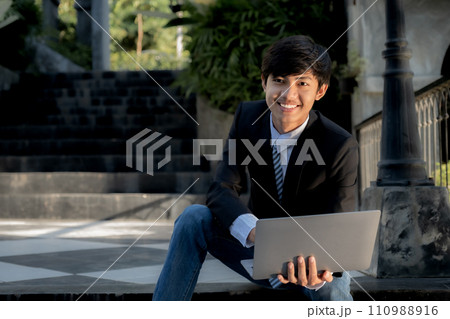 Successful businessman financier investors use laptops to communicate remotely over the internet or video call to set challenging business goals and ready to achieve targets from the outdoor hotel 110988916