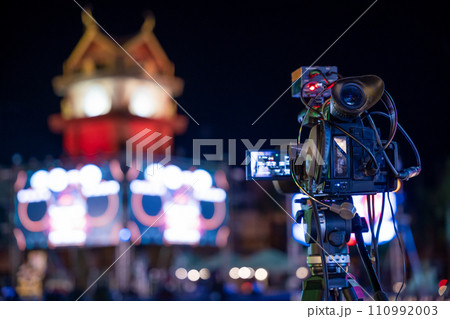 Professional video crew filming live event on stage. Expertise in movie production television streaming using multimedia equipment. Industry creativity in cinematography, Video equipment, media and TV 110992003