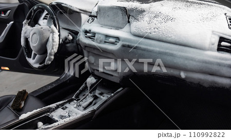 Car interior in a layer of cleaning foam.  110992822