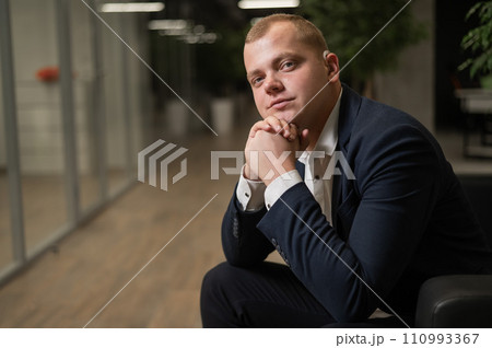 Portrait of a Caucasian man in a suit with a hearing aid. Portrait of a Caucasian man in a suit with a hearing aid. 110993367