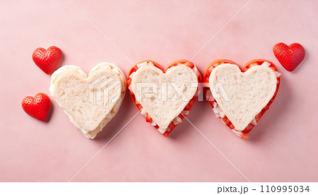 Heart-shaped sandwiches arranged on a table, flat lay composition 110995034