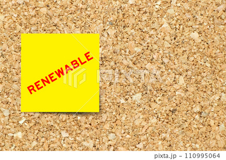Yellow note paper with word renewable on cork board background with copy space Yellow note paper with word renewable on cork board background with copy space 110995064