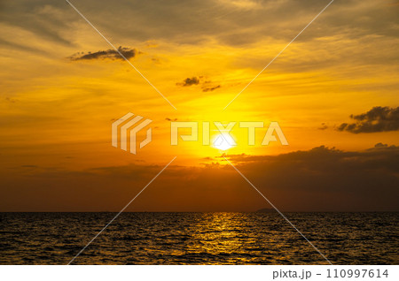 Fiery horizon, dramatic ocean sunset in vibrant hues over dark waters, nature breathtaking photo reflecting artistry of dusk's tranquil spectacle and coastal beauty Fiery horizon, dramatic ocean sunset in vibrant hues over dark waters, nature breathtaking photo reflecting artistry of dusk's tranquil spectacle and coastal beauty 110997614