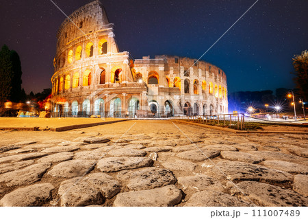 Rome, Italy. Colosseum Also Known As Flavian Amphitheatre In Night. Calmness Night Time. Bright Blue Night Starry Sky. Amazing Star Sky. Travel Italy Concept. Spirit Of Travel. Zeitgeist 111007489