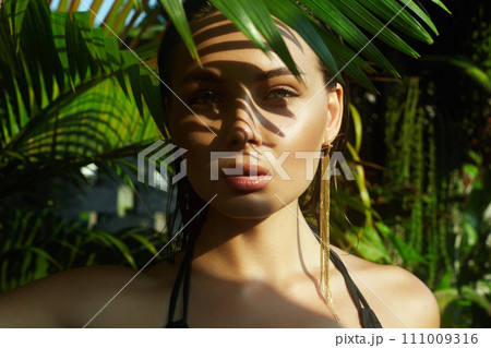 beautiful summer girl. young sexy woman in bikini under palm tree 111009316